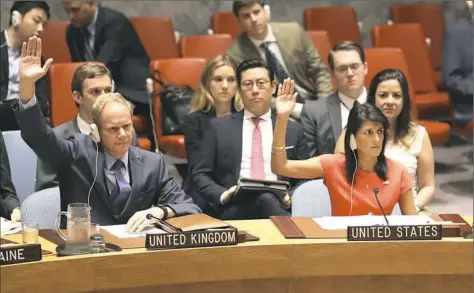  ??  ?? British Ambassador to the United Nations Matthew Rycroft, left, and U.S. Ambassador to the United Nations Nikki Haley vote during a Security Council meeting on a new sanctions resolution that would increase economic pressure on North Korea to return to...
