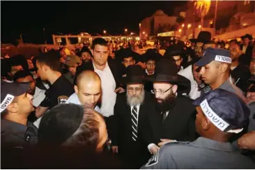  ??  ?? POLICE ESCORT newly elected Sephardi Chief Rabbi Yitzhak Yosef to the Western Wall.