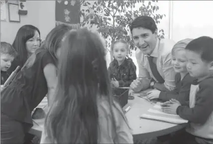  ?? JOHN WOODS, THE CANADIAN PRESS ?? Prime Minister Justin Trudeau meets with children at a YMCA-YWCA daycare centre in Winnipeg, on Wednesday.