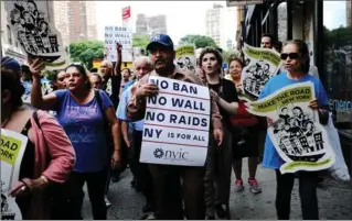  ?? SPENCER PLATT, GETTY IMAGES ?? Recent immigrants join activists for an evening protest in Manhattan over the U.S. travel ban.