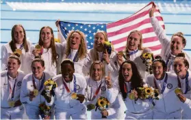  ?? ;Alexandria Garcia / New York Times ?? Members of the U.S. women's water polo team with their gold medals after defeating Spain at the Summer Olympics in Tokyo. The U.S. won a total of 113 medals, 39 of them gold. China had 88 total medals and 38 golds.