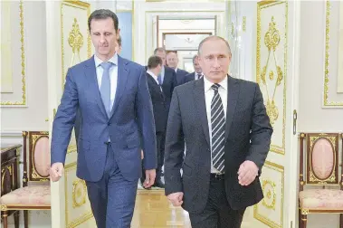  ?? ALEXEI DRUZHININ/RIA-Novosti, Kremlin Pool Photo via AP ?? Syria President Bashar Assad, left, and Russian President Vladimir Putin arrive for their meeting in the Kremlin in Moscow
on Tuesday. It’s the first time Assad has ventured out of his country in more than four years.