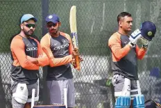  ?? Virendra Saklani/Gulf News ?? Indian captain Rohit Sharma with Jasprit Bumrah and Mahendra Singh Dhoni during a practice session yesterday.