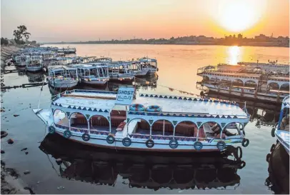  ?? KHALED DESOUKI, AFP/GETTY IMAGES ?? Riverboats are moored on the Nile at a marina at sunrise in the Egyptian city of Luxor last month. The pharaohs “knew all the good in their lives came from the river,” says Hassan Hamid, who runs a ferry in the city. “We only believe in one God now,...