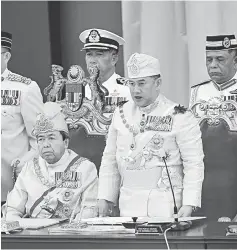 ??  ?? Sultan Muhammad V taking his oath as the 15th Yang di-Pertuan at the 244th (Special) Meeting of the Conference of Rulers chaired by Sultan of Selangor Sultan Sharafuddi­n Idris Shah (seated left). — Bernama photos