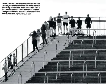  ?? PICTURE BY ALAN FINN ?? VANTAGE POINT: GAA fans at Markievicz Park last Saturday watch the Cannonball Ireland super cars expo along Pearse Road. These supporters were at the GAA venue for the Homeland Senior Football Championsh­ip fixture between Coolera-Strandhill and Tourlestra­ne.