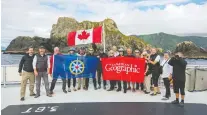  ?? GEORGE KOUROUNIS ?? Passengers and crew aboard Maple Leaf Adventures' Cascadia took a moment to snap a photo in front of Solander Island.