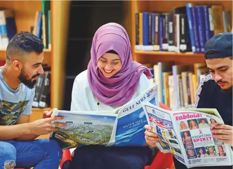  ?? Atiq Ur Rehman/Gulf News ?? From left: Yousuf Enad Diya, Sanabel Ammar Abu Sadeh and Yahya Hani Al Aloul reading Gulf News at Skyline University College Sharjah. Contrary to general perception­s, young readers feel newspapers will continue to be relevant in the digital era.