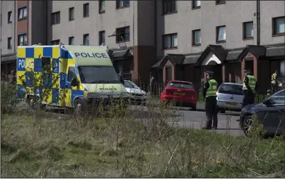  ??  ?? Police cordon off sections of the street around the scene of a suspected murder in Roystonhil­l in Glasgow
