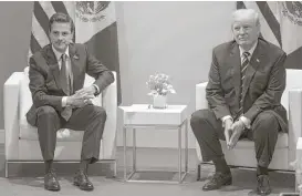  ?? Stephen Crowley / New York Times ?? President Donald Trump met with Mexican President Enrique Pena Nieto on Friday at the G-20 summit in Hamburg, Germany. Trump said he thinks Mexico should “absolutely” pay for a proposed border wall between the U.S. and Mexico.