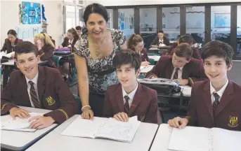  ??  ?? IT ALL ADDS UP: Dominic College mathematic­s teacher Sunita Kumrai with some of the school’s high-achieving students, from left, Max Brideson, Oscar Breslin and Harry Breslin.