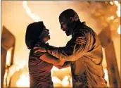  ?? MPAA rating: Running time: KIMBERLEY FRENCH/UNIVERSAL PICTURES ?? Neve Campbell, left, and Dwayne Johnson star as a heroic couple in the blockbuste­r action movie “Skyscraper.”
PG-13 (for sequences of gun violence and action, and for brief strong language) 1:42