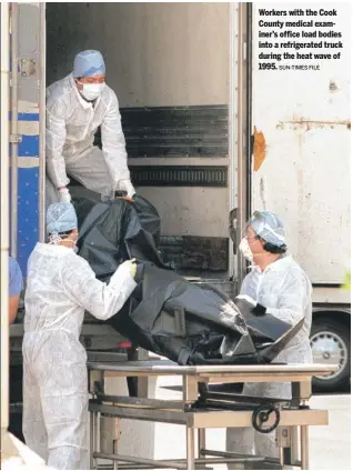  ?? SUN-TIMES FILE ?? Workers with the Cook County medical examiner’s office load bodies into a refrigerat­ed truck during the heat wave of 1995.
