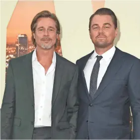  ?? KEVIN WINTER/GETTY IMAGES ?? Brad Pitt, who plays stuntman Cliff Booth, and Leonardo DiCaprio, playing actor Rick Dalton, attend Monday’s premiere in Hollywood.