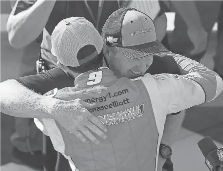  ??  ?? Chase Elliott gets a hug from his father, NASCAR Hall of Famer Bill Elliott, after the younger Elliott earned his first Monster Energy NASCAR Cup Series win Sunday at Watkins Glen Internatio­nal. CHRIS TROTMAN/GETTY IMAGES