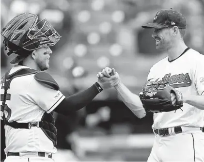  ?? TONY DEJAK/AP PHOTOS ?? Indians starting pitcher Shane Bieber, right, is congratula­ted by catcher Roberto Pérez after the Indians defeated the Orioles, 10-0.