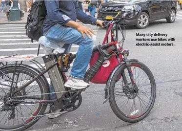  ?? GETTY ?? Many city delivery workers use bikes with electric-assist motors.