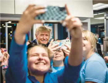  ?? DOUG MILLS/THE NEW YORK TIMES ?? Former President Donald Trump poses with backers Saturday in Columbia, South Carolina.