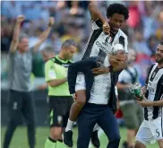  ?? AFP ?? Juan Cuadrado celebrates with Juventus coach Massimilia­no Allegri after winning the “Scudetto” at the Juventus Stadium in Turin.