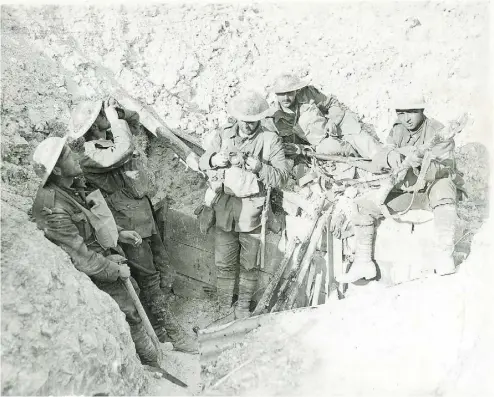  ?? DND ?? Canadian soldiers in a captured German trench during the Battle of Hill 70 in August 1917. More than 2,000 Canadians were killed in the 10- day battle, and many were buried quickly where they fell with no known graves.