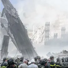  ?? REUTERS • FILE ?? A group of firefighte­rs stand on the street near the destroyed World Trade Centre in New York on Sept. 11, 2001.