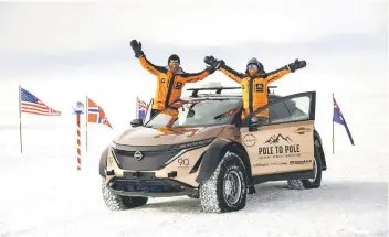  ?? — Photos from Chris Ramsey ?? Chris and Julie at the South Pole with the modified Nissan Ariya SUV they drove across North and South America to Antarctica.