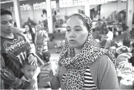  ?? AFP PHOTO ?? ‘ THERE’S NOTHING LEFT’
Rasmia Abdullah, 24, speaks during an interview at an evacuation center outside Marawi City, as fighting between government troops and Islamist terrorists rages. Nearly all of the 200,000 residents of Marawi have fled since...