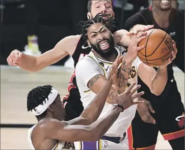  ?? Wally Skalij Los Angeles Times ?? THE LAKERS’ Anthony Davis, grabbing a rebound from the Heat’s Goran Dragic, will become a free agent.
