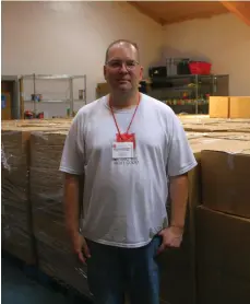  ?? (Matt Hutcheson/ News-Times) ?? Salvation Army food pantry manager David Johnson stands by the organizati­on’s senior boxes, which are both handed out from the pantry and delivered across the county by the SA on behalf of the Arkansas Food Bank. The SA’s food pantry is relatively well-stocked currently thanks to a food drive last month by the United States Post Office. Due to massively increased demand, however, SA administra­tion is worried the pantry will deplete quickly during the donation-light summer months.