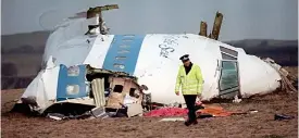  ?? ?? Atrocity: Policeman at the wreckage site of Pan Am Flight 103