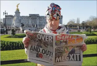  ?? Associated Press photo ?? Self-proclaimed royal super-fan John Loughrey poses for the media backdroppe­d by Buckingham Palace in London Thursday. In a statement Prince Harry and his wife, Meghan, said they are planning “to step back” as senior members of the royal family and “work to become financiall­y independen­t.”