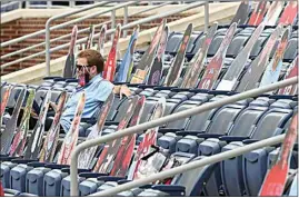  ?? THOMAS GRANING / AP ?? A fan sits among cardboard cutouts of other fans before the first half of Saturday’s college football game between Mississipp­i and Florida in Oxford, Miss.