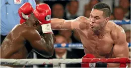  ?? PHOTOSPORT ?? Joseph Parker lands a big right hand on Carlos Takam in May.