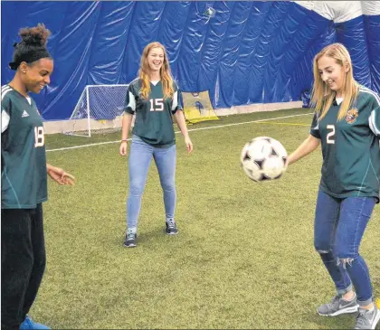  ?? SALTWIRE NETWORK PHOTO/CAPE BRETON POST ?? Cape Breton Capers soccer players (from left) Tamara Brown, Robyn Novorolsky and St. John’s native Alyssa Armstrong play around with a soccer ball in Sydney, N.S., on Monday. The Atlantic University Sport champion Capers compete in the national soccer...