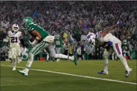  ?? MATT SLOCUM — THE ASSOCIATED PRESS ?? Philadelph­ia Eagles quarterbac­k Jalen Hurts scores the game-winning touchdown against the Buffalo Bills during overtime Sunday in Philadelph­ia.