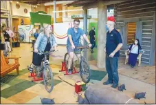  ?? (Courtesy photo) ?? Adult Night participan­ts use stationary bikes to generate power for LED racers at the Amazeum on Sept. 23.