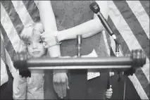  ?? TOM BRENNER / THE NEW YORK TIMES ?? A child with pre-existing conditions covered by the Affordable Care Act stands with his mother during a July 12 Capitol Hill news conference with Democratic senators about healthcare.