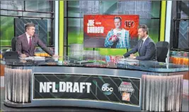  ?? Allen Kee The Associated Press ?? With 6 feet of separation, ESPN’S NFL draft host Rece Davis, left, and analyst Jesse Palmer discuss the No. 1 selection of QB Joe Burrow by the Bengals on Thursday.