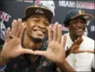  ?? CARL JUSTE — MIAMI HERALD VIA AP ?? Teammates Mark Pope, left, and Daquris Wiggins, gesture after signing with the Miami Hurricanes NCAA college football team at Miami Southridge High in Miami, Fla., Wednesday.