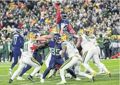  ?? USA TODAY SPORTS ?? Titans running back Derrick Henry, top, throws a pass for a touchdown against the Packers at Lambeau Field in Green Bay.