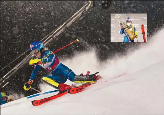  ??  ?? United States’ Mikaela Shiffrin speeds down the course during an alpine ski, women’s World Cup slalom in Flachau, Austria, on Jan 12. (Inset): Shiffrin poses with the trophy after winning an alpine ski, women’s World Cup slalom. (AP)