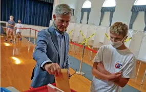  ?? MATT sToNE / HErAld sTAFF ?? ‘REPUBLICAN­S CAN WIN’: Kevin O’Connor, who’s running against Shiva Ayyadurai in the GOP primary, casts his vote on Wednesday at Dover Town Hall alongside his son Matt.