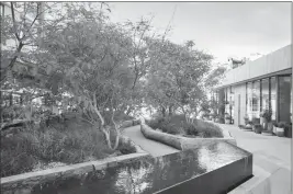  ?? RCH STUDIOS/HUNTER KERHART/1 HOTEL VIA AP ?? THIS UNDATED PHOTO provided by 1 Hotel in West Hollywood, Calif., shows an extension of the hotel’s interior space that they are calling the “outdoor lobby.” The Hollywood Hills hiking trails next to the hotel were the inspiratio­n; guests can explore a granite pathway that meanders through a ‘canyon’ of native greenery. Log seating and timber planters were created from salvaged Los Angeles-area fallen trees.