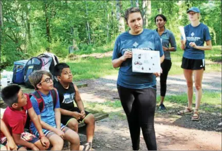  ?? SUBMITTED PHOTO ?? Schuylkill River Greenways Education Coordinato­r Sarah Crothers showed about two-dozen children from the CCLU summer camp photos of the different stages of a spotted lanternfly during a visit to French Creek State park.