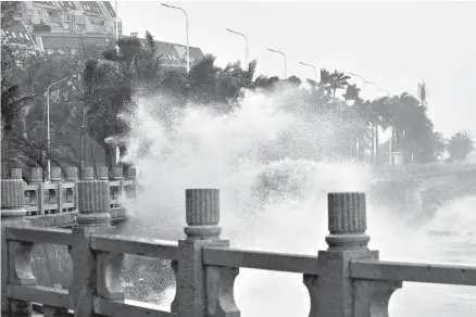  ?? Liang Xu/Xinhua via AP/Associated Press ?? ■ Waves crash onto the coastline Sunday in Zhuhai in southern China’s Guangdong Province. Typhoon Mangkhut pummeled southern China on Sunday after lashing the northern Philippine­s with strong winds and heavy rain that left at least 64 people dead and dozens more feared buried in a landslide.