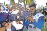  ?? GUS RUELAS/THE ASSOCIATED PRESS ?? Cowboys running back Ezekiel Elliott signs autographs Tuesday in Oxnard, Calif.