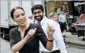  ?? MARK LENNIHAN/AP ?? Alexandria Ocasio-Cortez reacts to a passer-by Wednesday, the day after her primary victory in New York.
