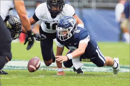  ?? Stew Milne / Associated Press ?? UConn quarterbac­k Steven Krajewski (8) looks to recover a fumble during the first half against Purdue on Saturday in East Hartford.