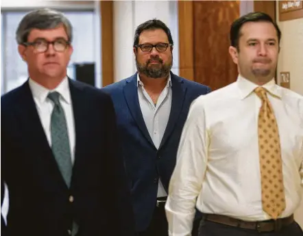  ?? Godofredo A. Vasquez / Staff photograph­er ?? Opera singer David Daniels, center, and his husband, William Scott Walters, right, maintained their innocence in a brief court appearance on Monday. The couple are accused of sexually assaulting a former Rice University student in 2010.