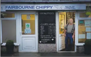  ?? ?? Alan Peter Jones, who owns Fairbourne Chippy, stands in the doorway of his business.